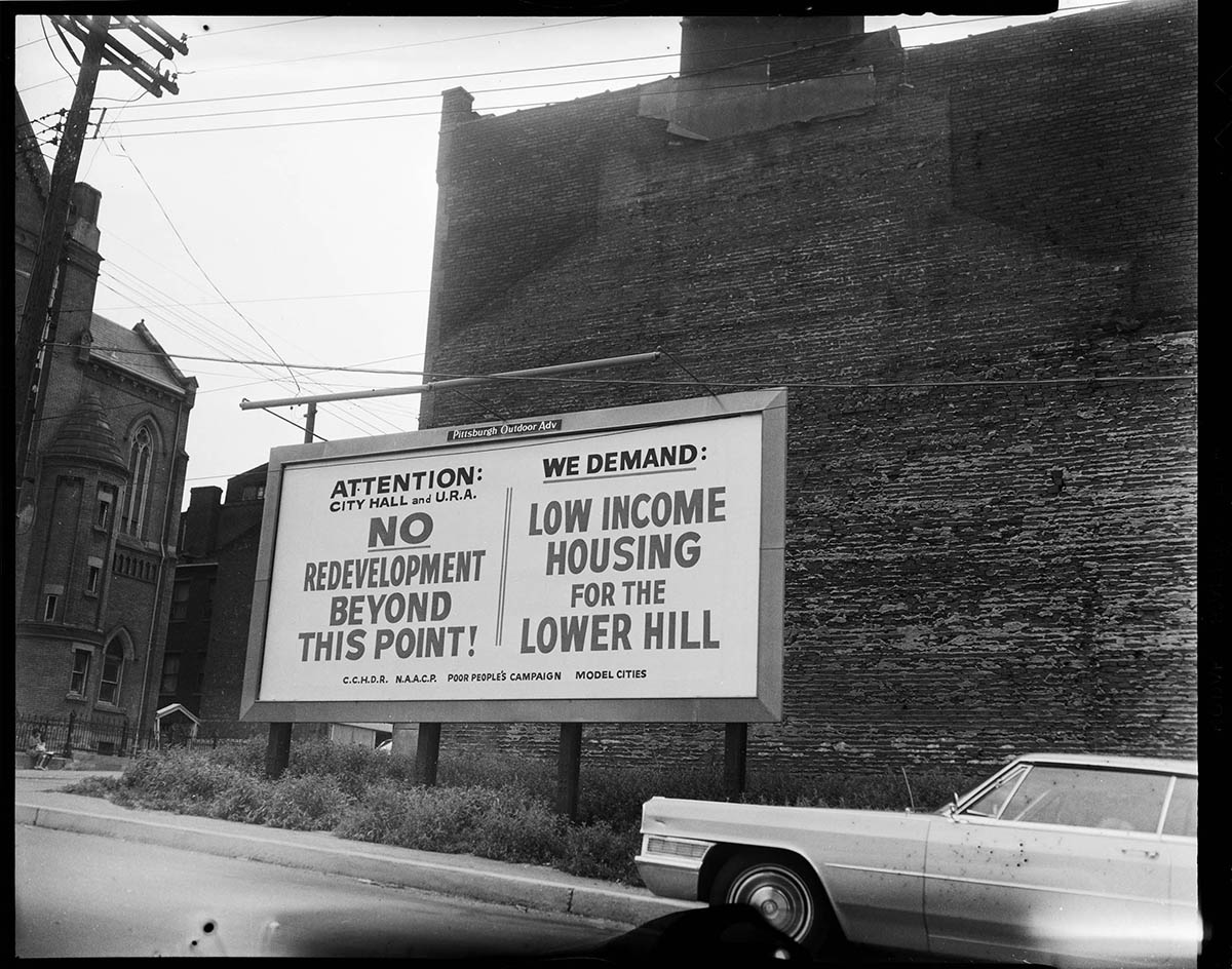 billboard at the corner of Crawford Street and Centre Avenue, denouncing the redevelopment of the lower Hill District, 1969. Carnegie Museum of Art, Heinz Family Fund.