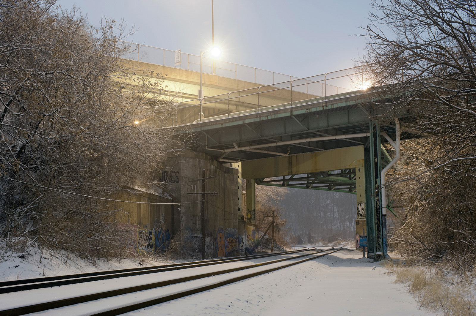Railroad under bridge during winter