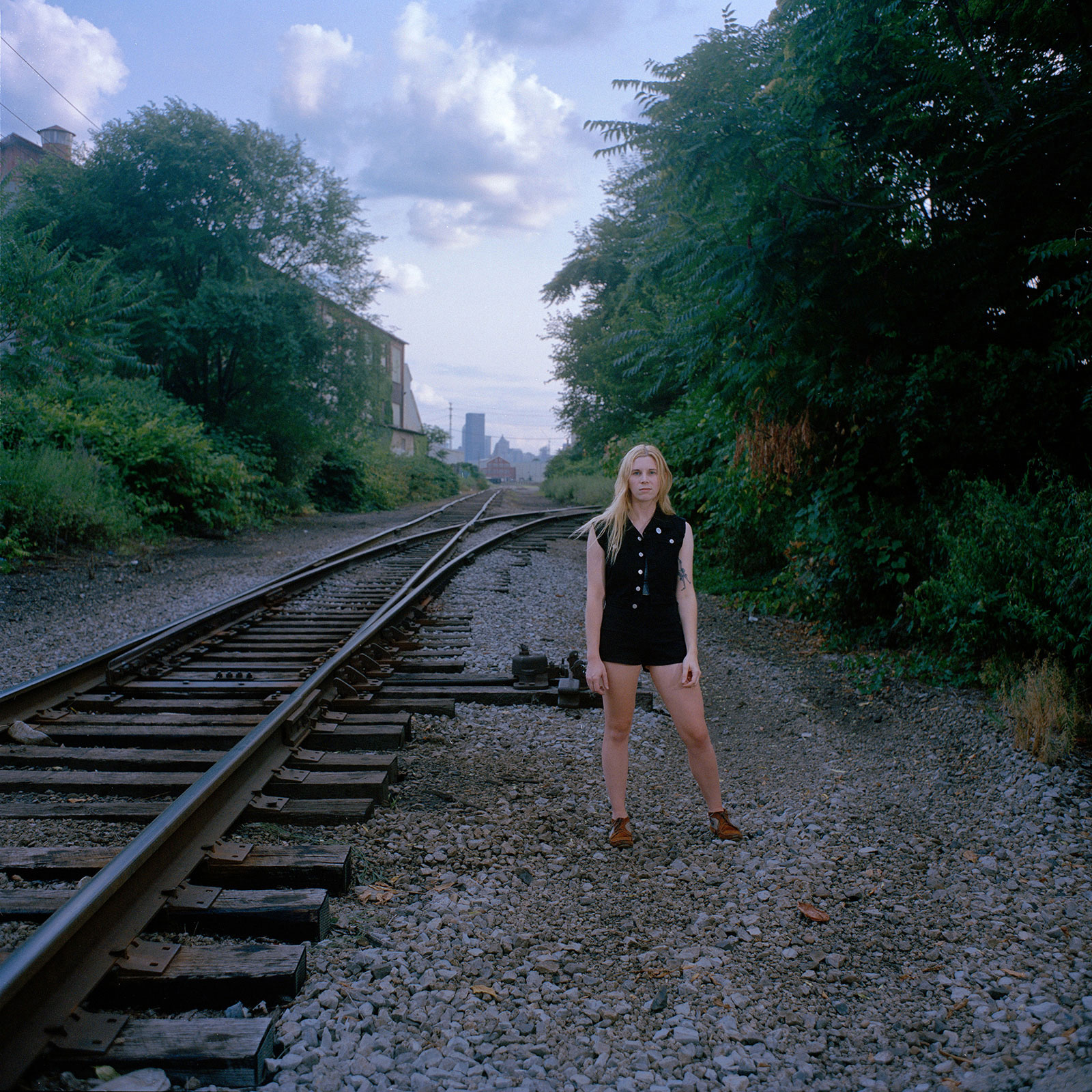 Woman standing next to train tracks