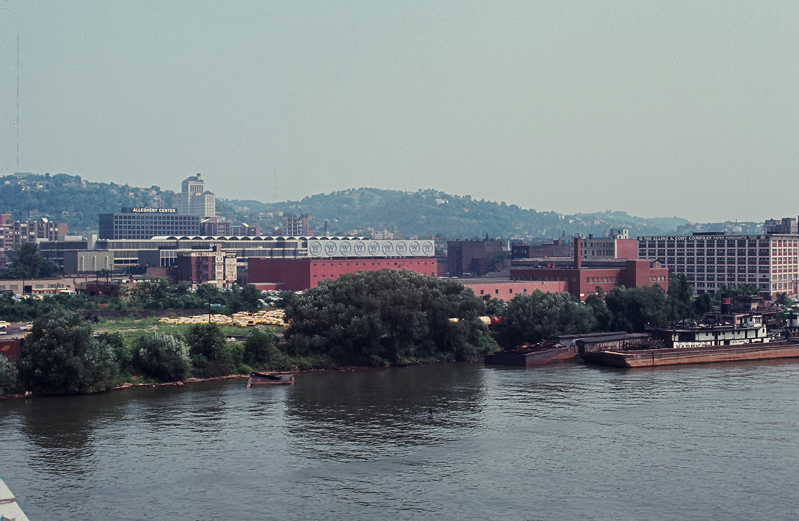 Pittsburgh buildings and factories along the riverbank.