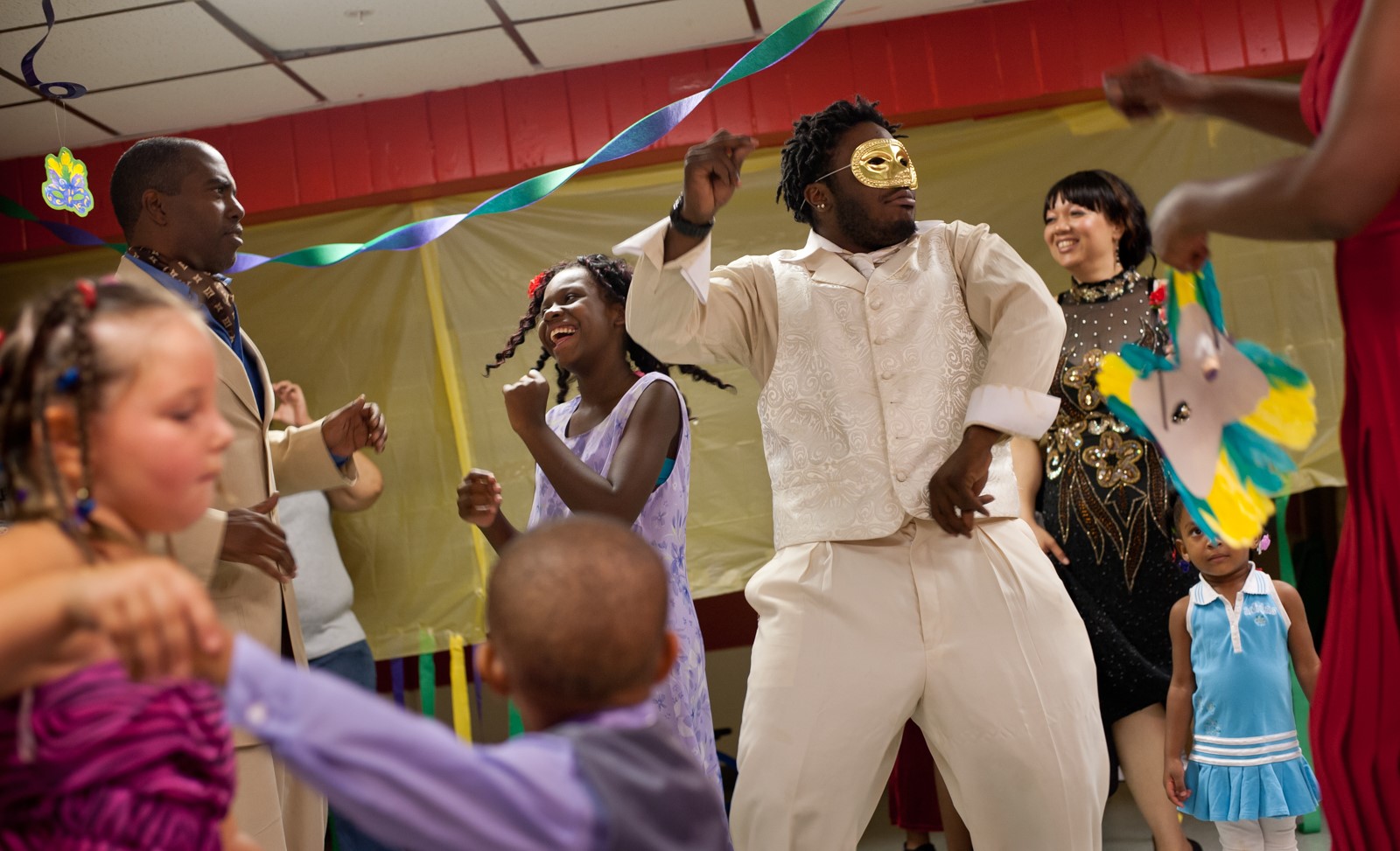 A man dances at a Mardi Gras-themed party.