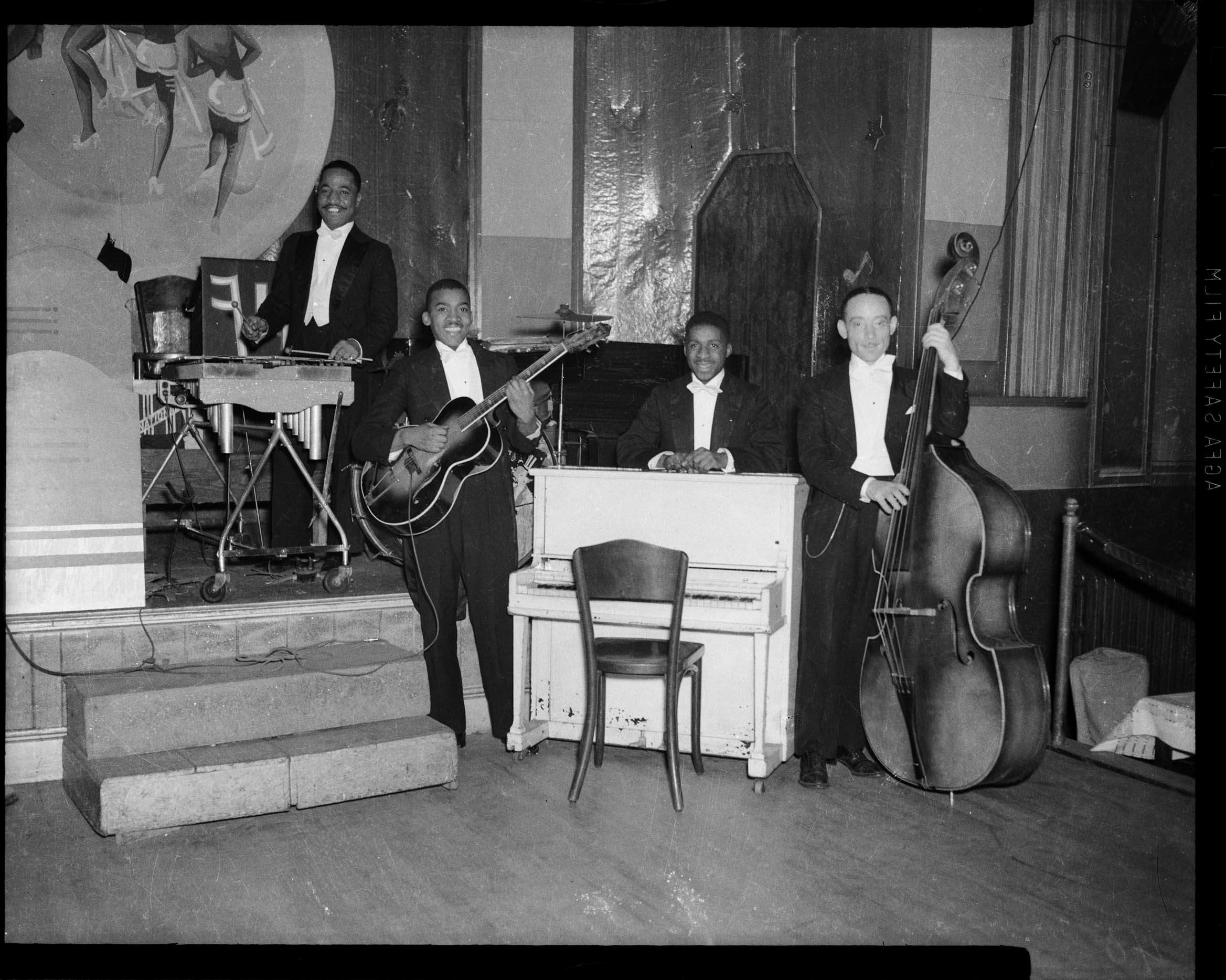 Charles Teenie Harris, James Honey Boy Minor on percussion, Joe Westray on electric guitar, Erroll Garner behind piano, and George Ghost Howell on bass, on stage of Harlem Casino, ca. 1939-1940, black and white: Agfa Safety Film, Carnegie Museum of Art, Heinz Family Fund