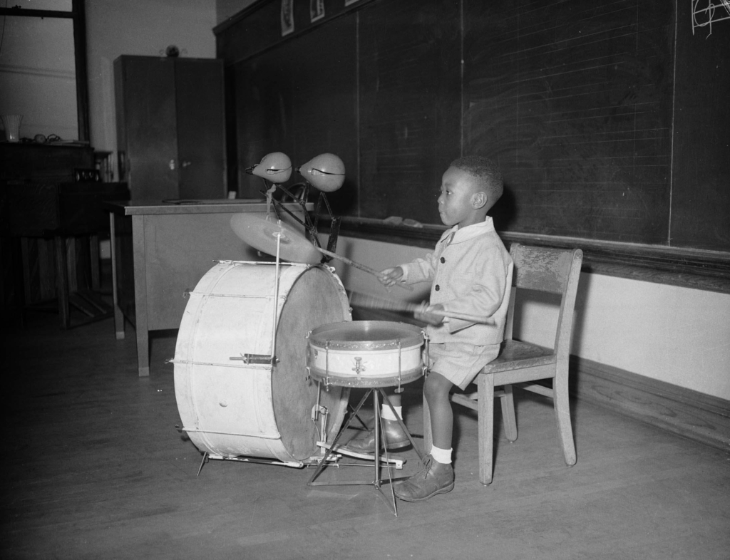 Charles Teenie Harris photo depicts a small boy playing the drums