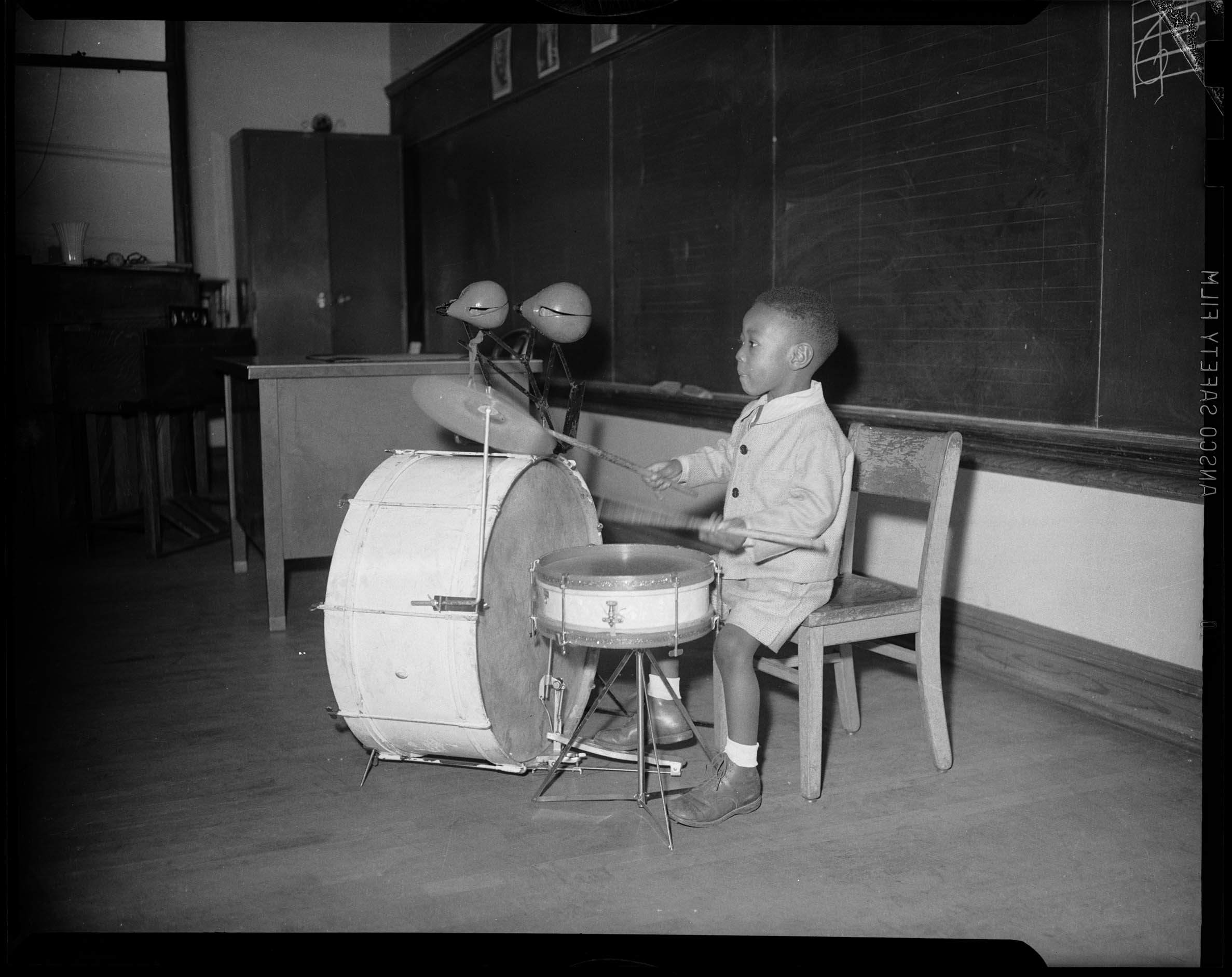 Charles Teenie Harris photo depicts a small boy playing the drums
