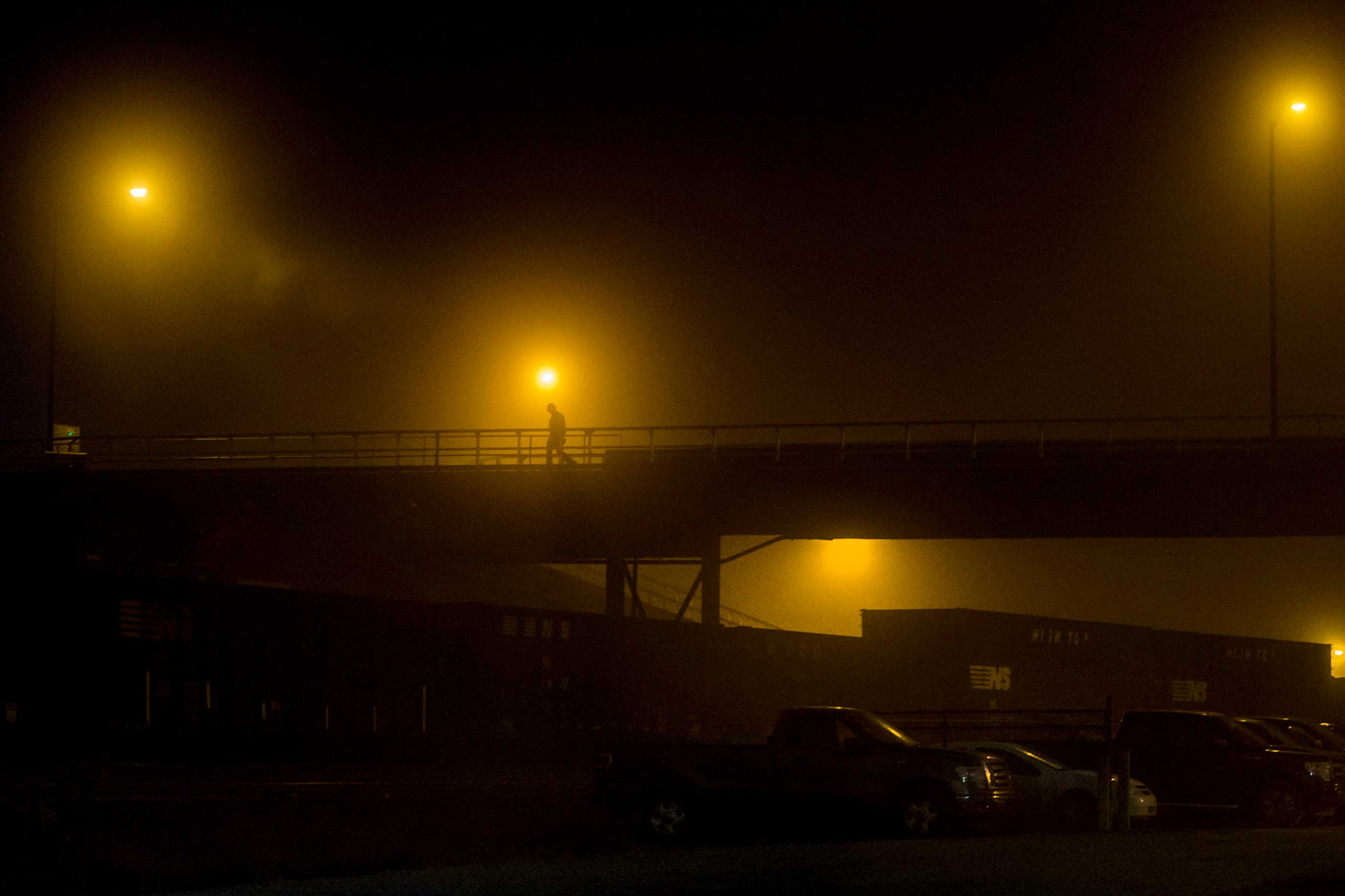 A worker makes his way to the Clairton Coke Plant in Clairton, PA. during early morning shift change.