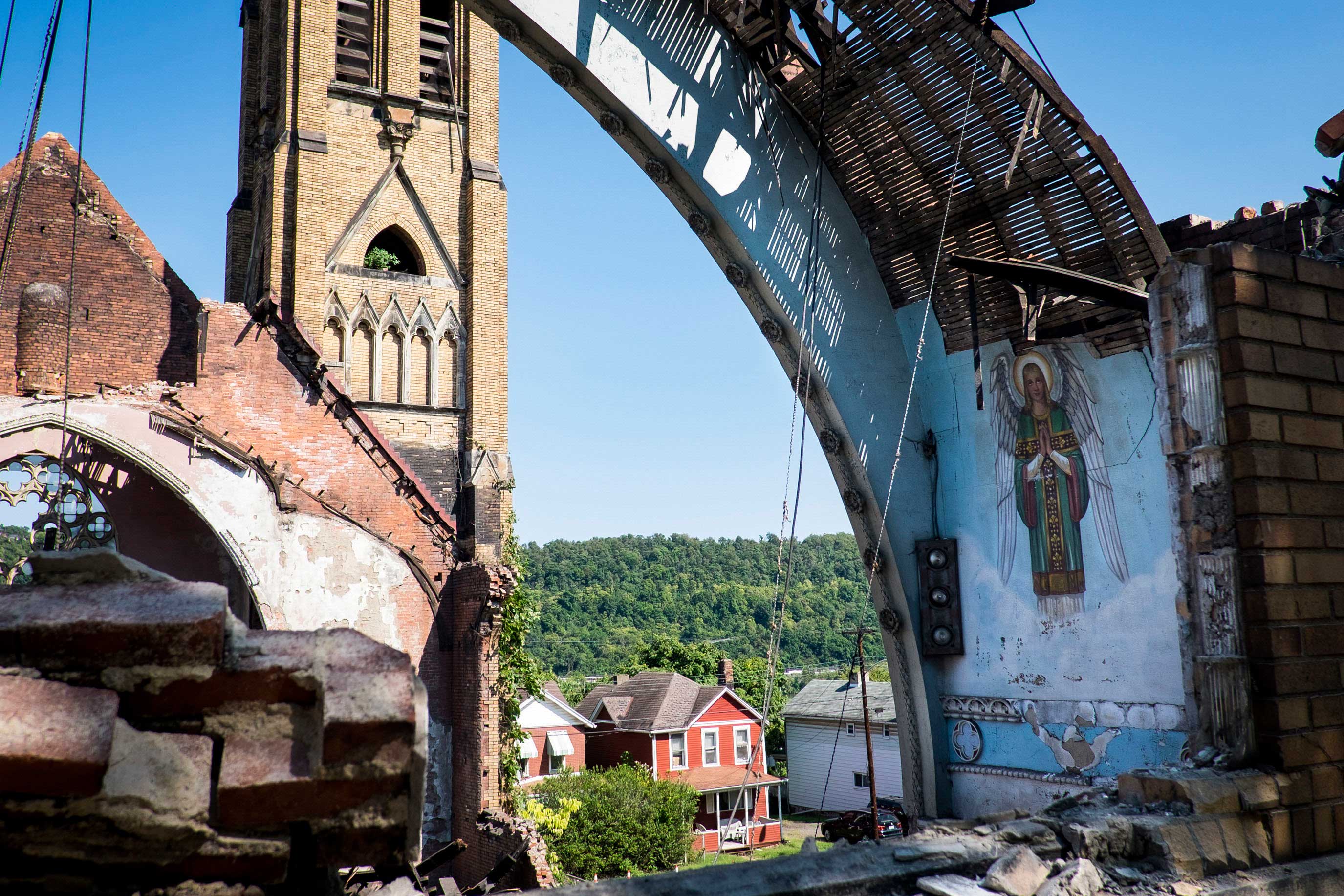 Holy Trinity Church in Duquesne being demolished after a storm caused the roof to collapse and make the rest of the structure unsafe.