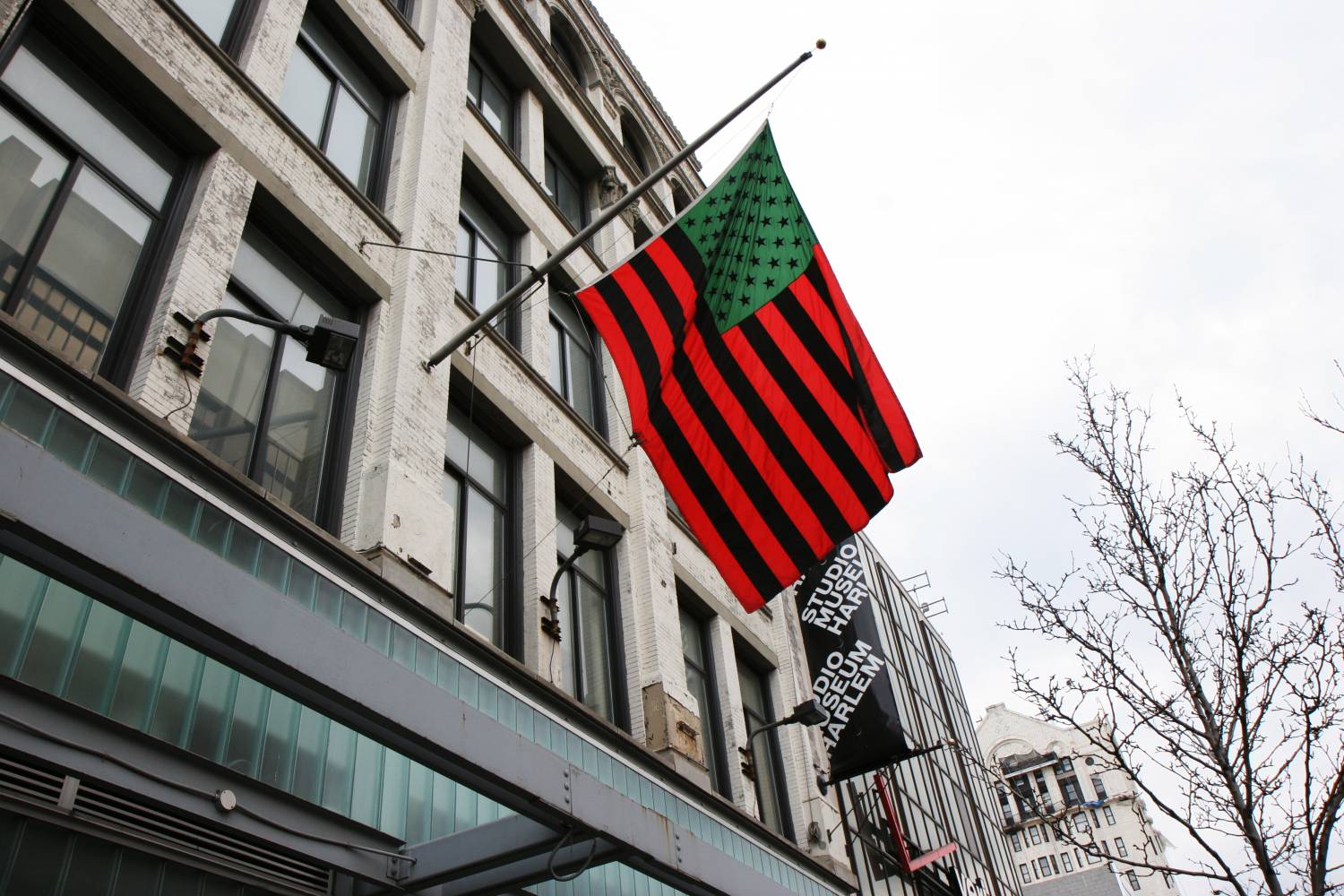 A red, black, and green American flag flies outside Harlem's Studio Museum.
