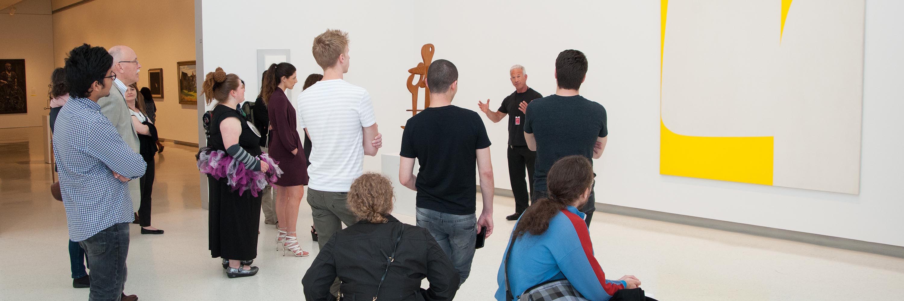Tour guide discusses art with a group of people