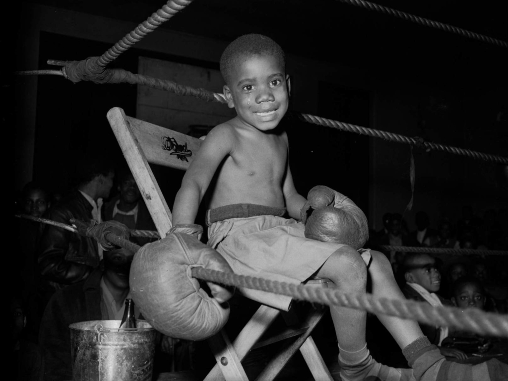 A boy in a boxing ring: Photo by Charles Teenie Harris