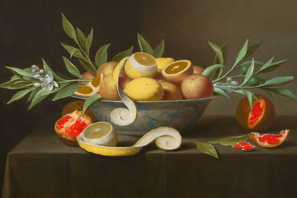 A bowl of vibrant lemons, grapefruit, and pomegranates