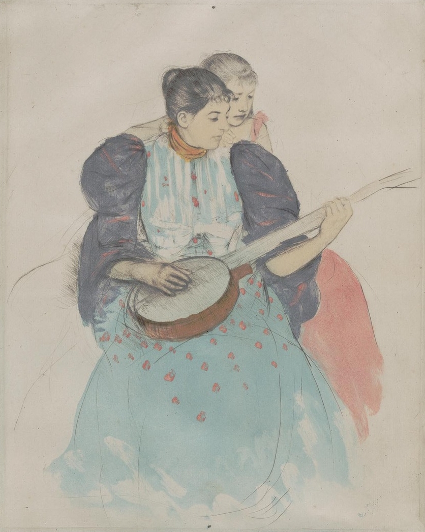 One woman sits holding a banjo in her lap while another woman is seated behind her, looking over her shoulder and watching her play.
