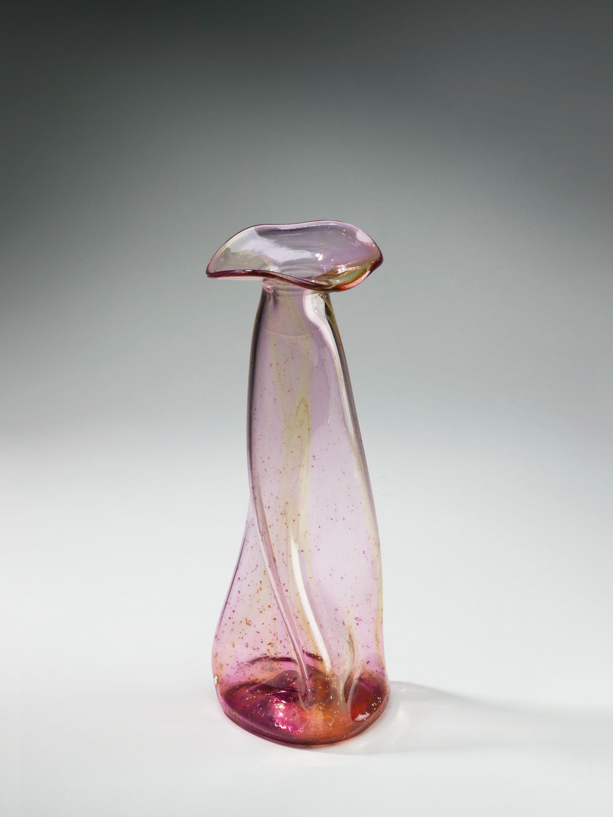 A twisted, tall glass vase with a small mouth.
