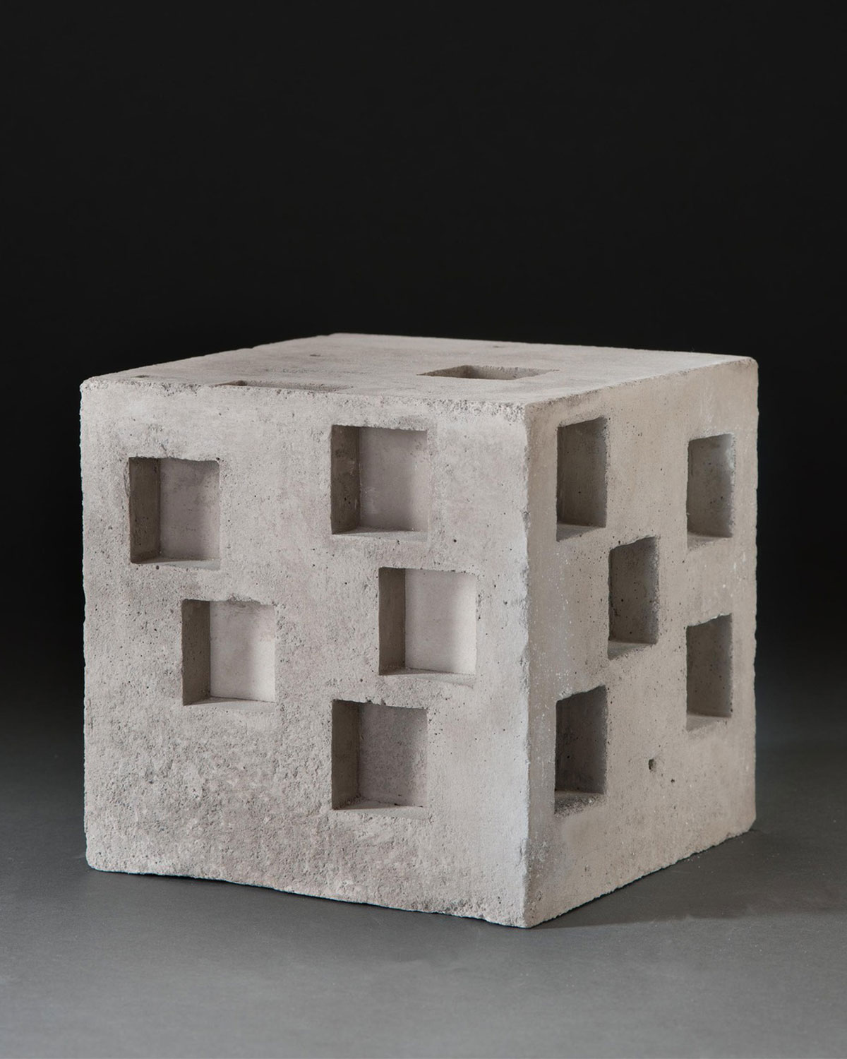 A concrete cube with windows cut into it