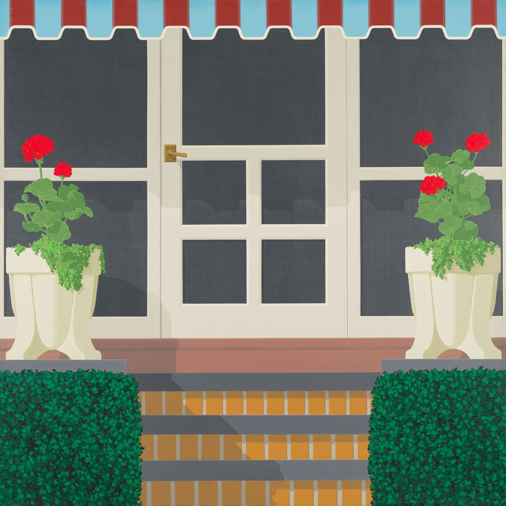 A closely cropped view of the front of a house. The door is centered and flanked by two pots of red flowers that sit atop both sides of a short brick staircase.