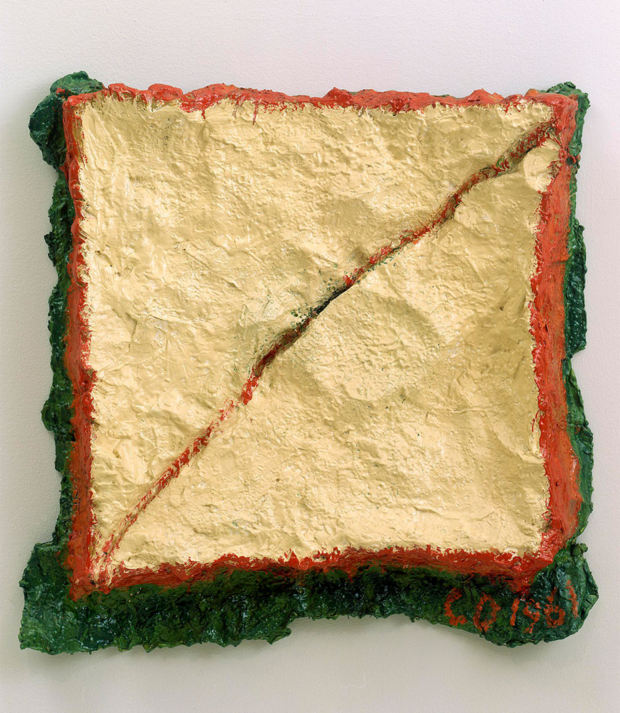 A textured sculpture that appears to be a sandwich on white bread, sliced diagonally