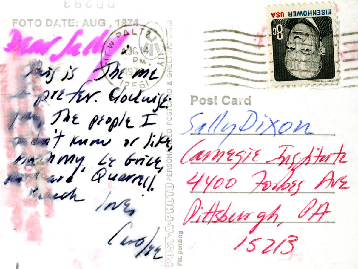 A postcard with a colorful address on the right side with looping handwriting on the left, which is partially obscured from a water stain