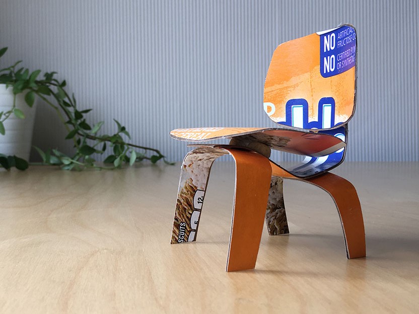 A miniature chair made out of cardboard.