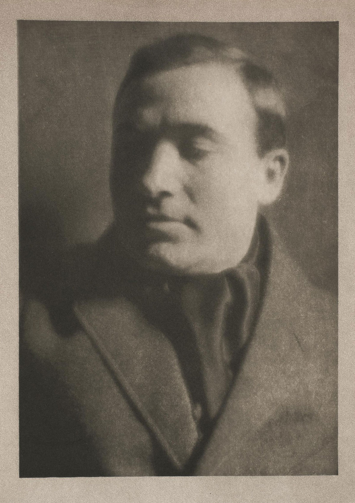 An old-fashioned portrait of a man with short hair and closed eyes, wearing a heavy jacket and ascot