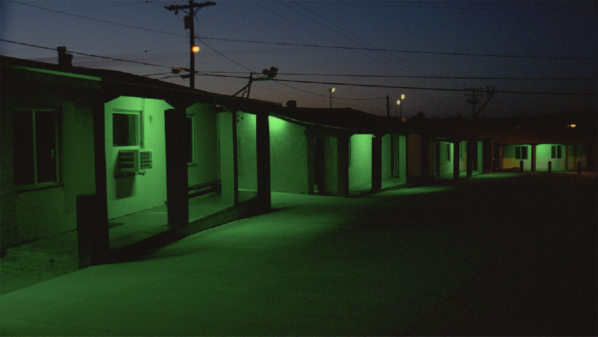 A dimly lit row of motel rooms