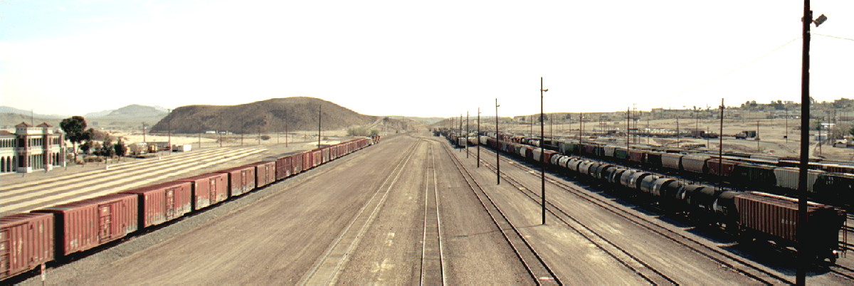 A view of rails on a railroad converging towards the distance