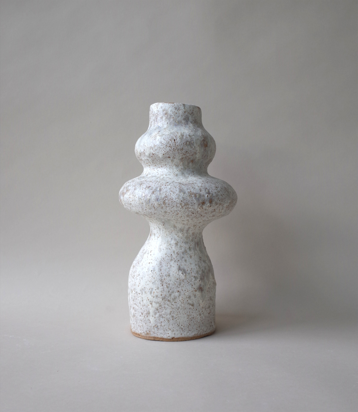 Product shot of minimalist ceramic figure with light glaze.