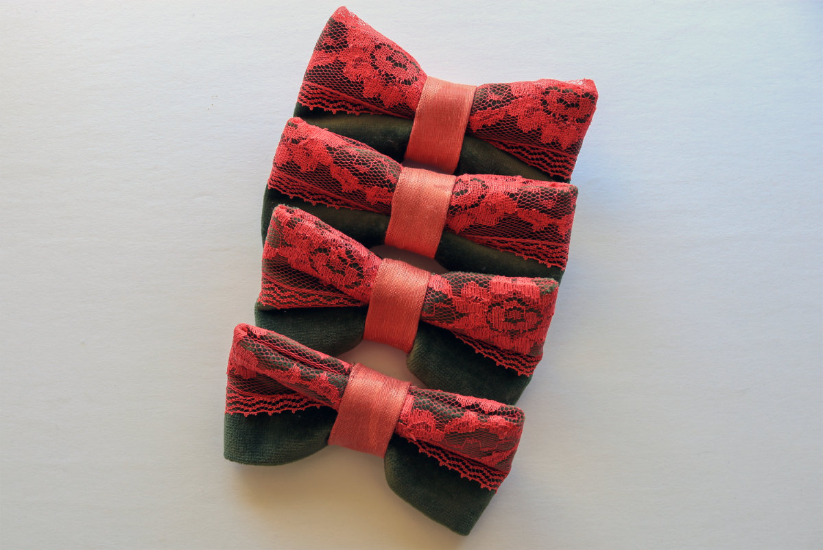 Product shot of hand made red bow ties arranged in a diagonal line