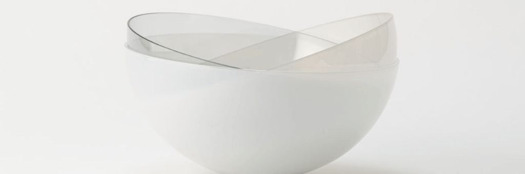 Glass and transparent bowls stacked against a white background