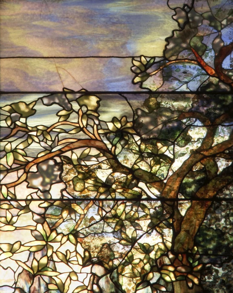 A window panel featuring a flowering tree pattern