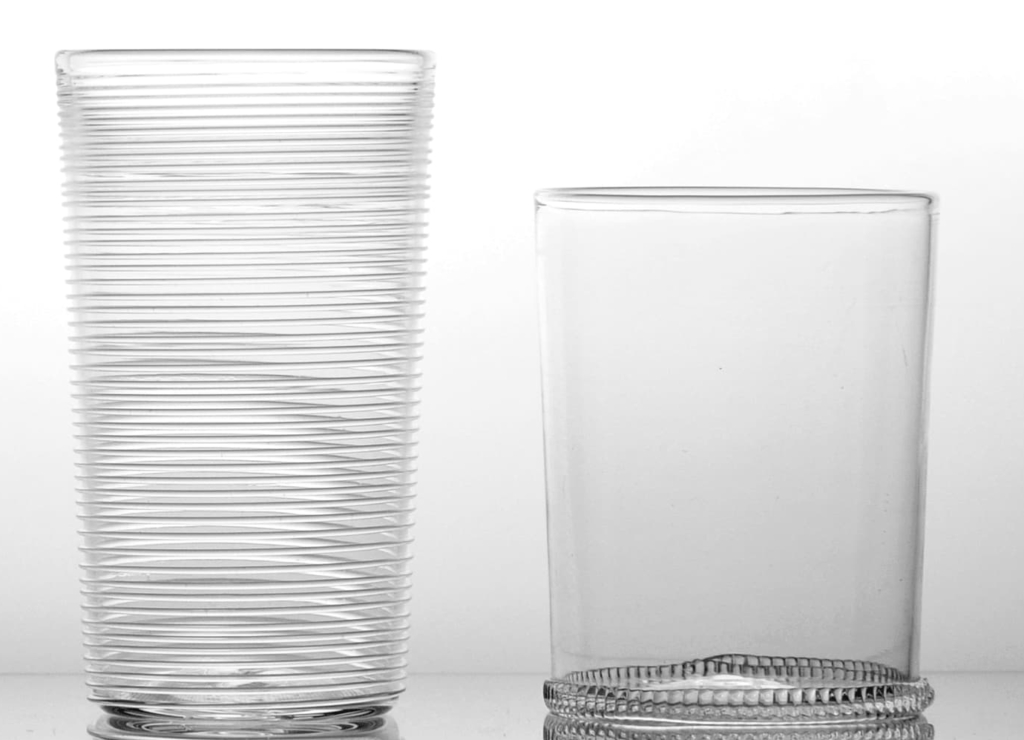 Four clear glasses against a white background