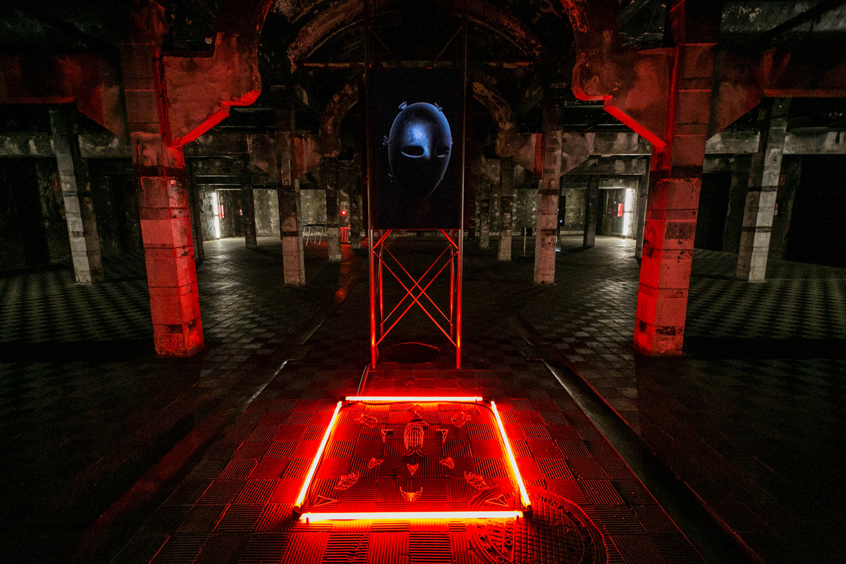 A dungeon chamber with an alter outlined by red neon tubes.