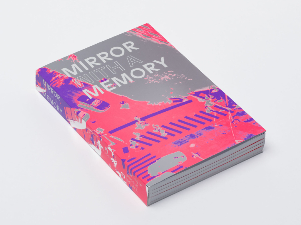Book jacket for Mirror with a Memory, features high-contrast three-tone image of figure being viewed from above
