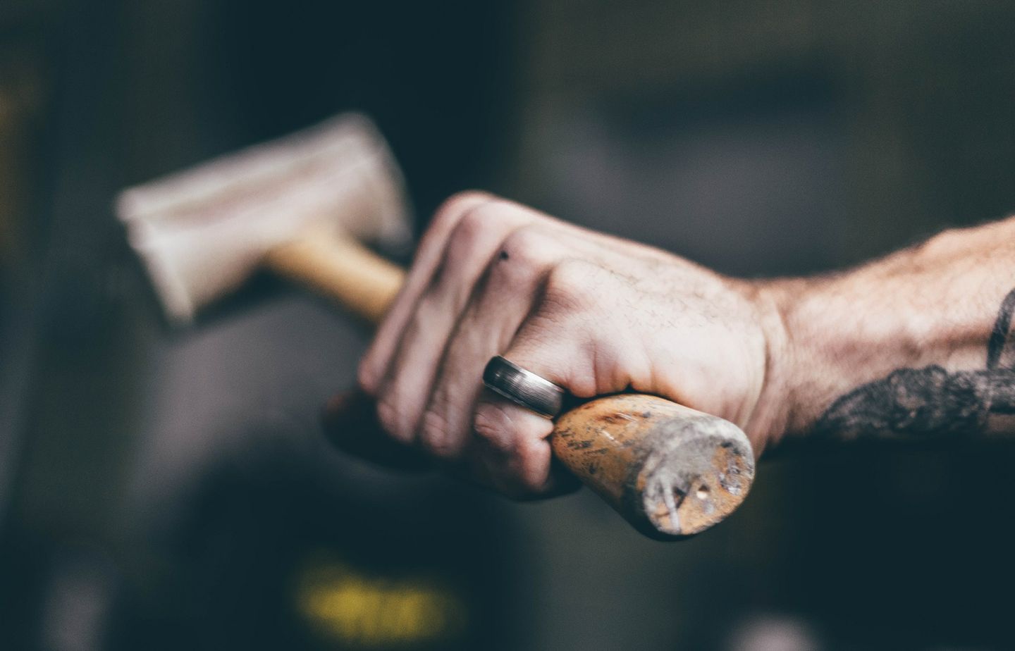 An industrious hand holding a hammer.