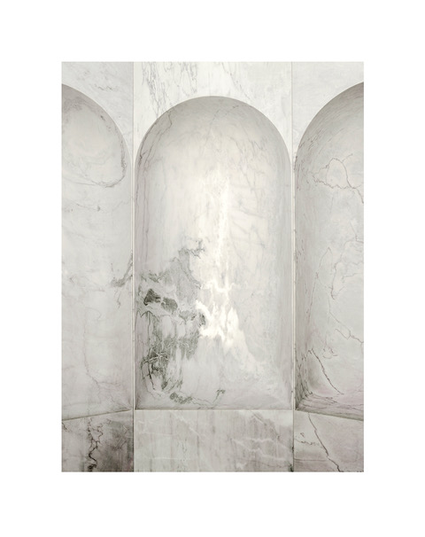 Minimalist photograph of a marble wall in a chapel.