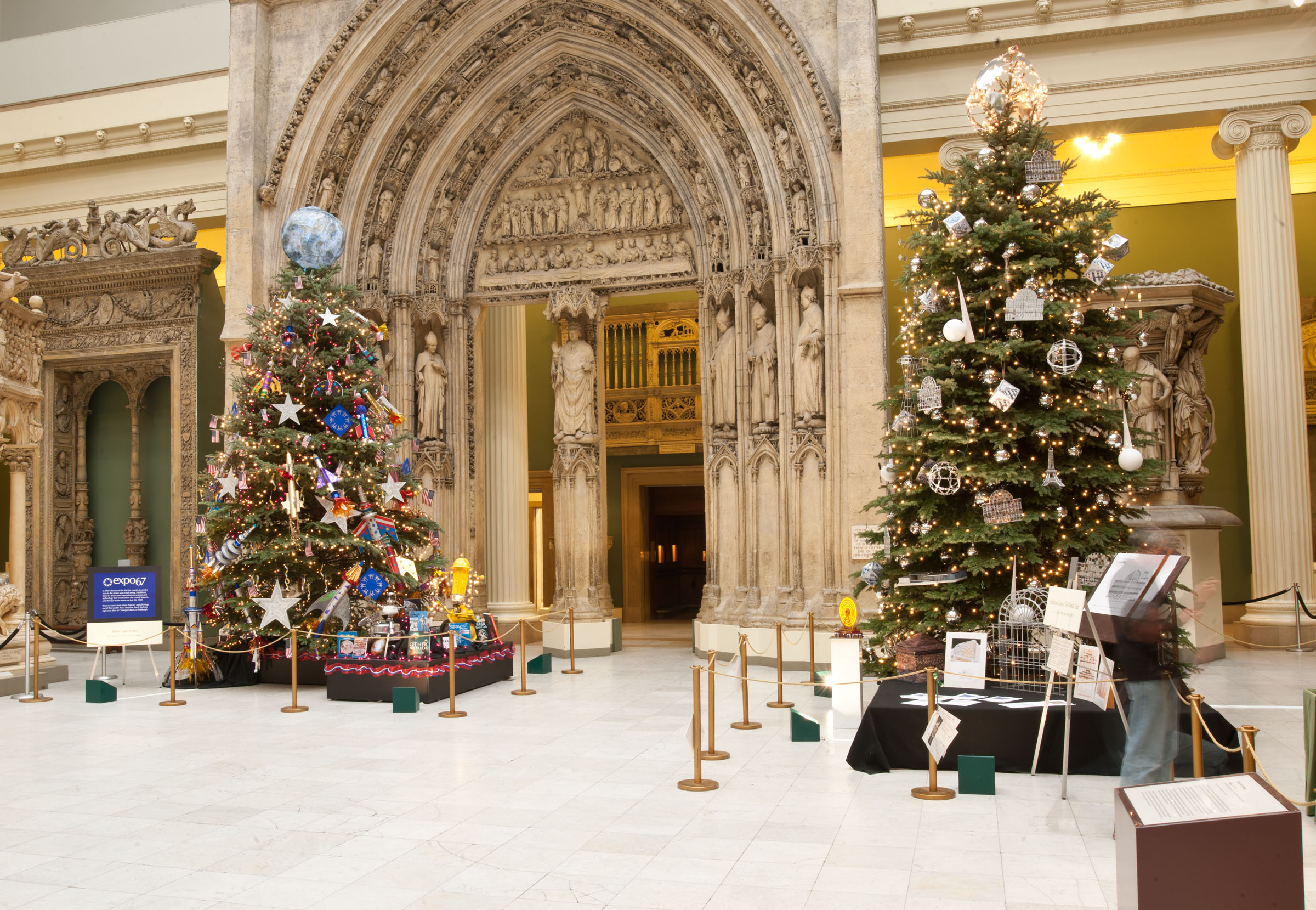 Two large Christmas trees in an ornate setting