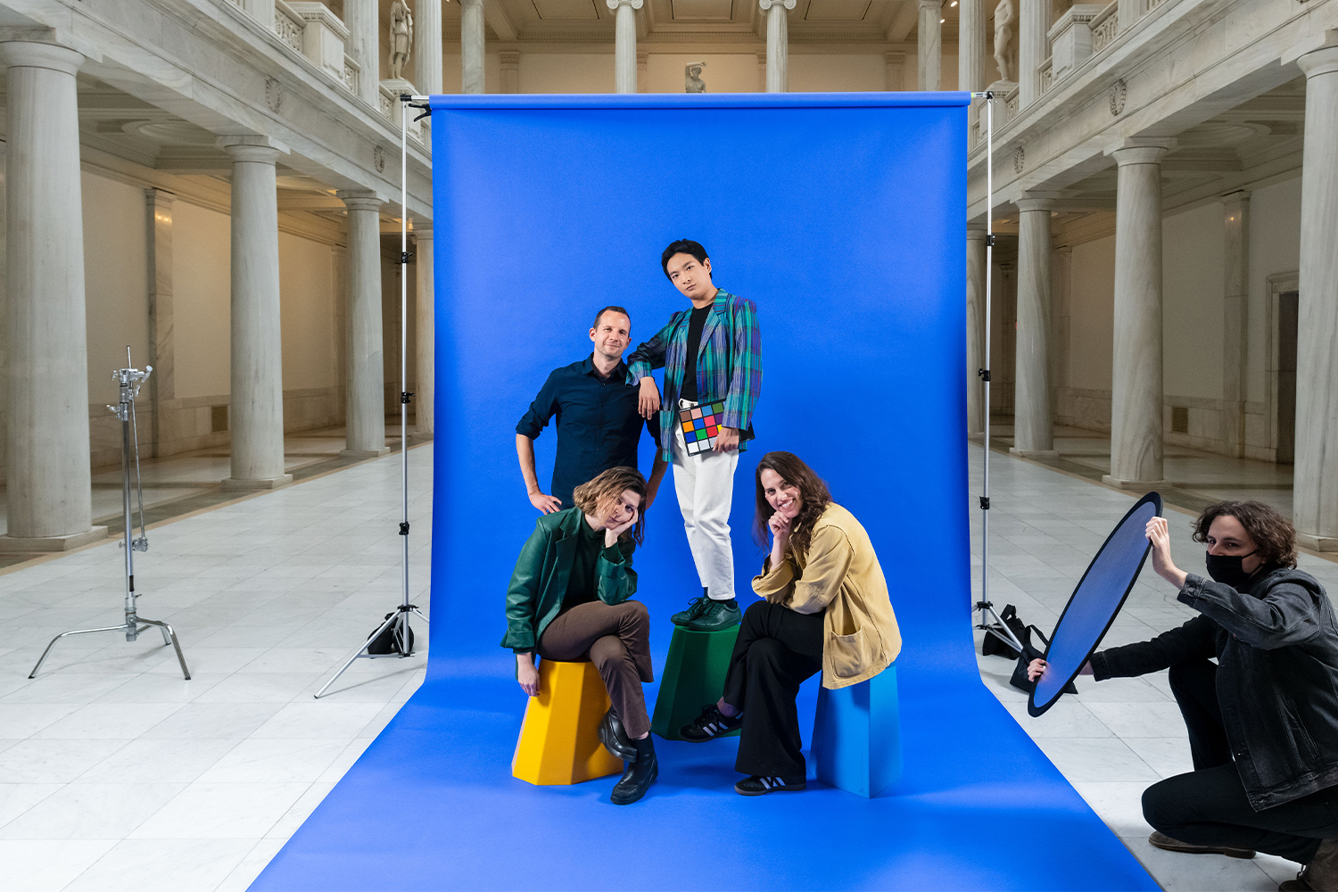 People pose for a photo in front of a green screen