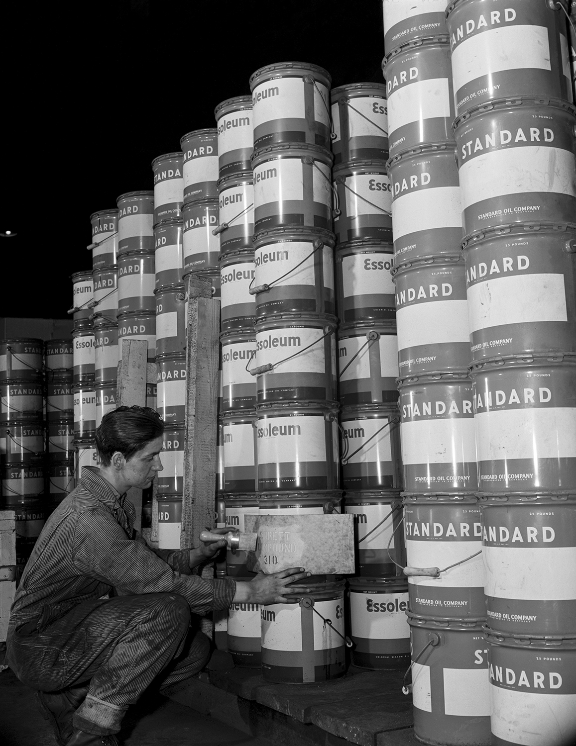 A person attaching a label onto a can