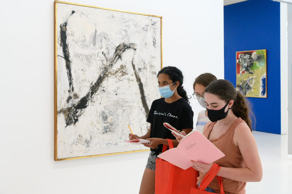 Summer camp students in a gallery