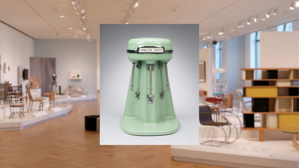 A stand mixer in front of a gallery