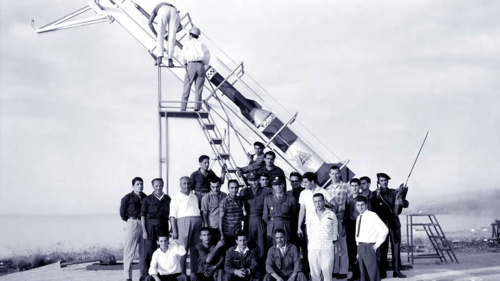 Photograph of men standing around a rocket in Lebanon