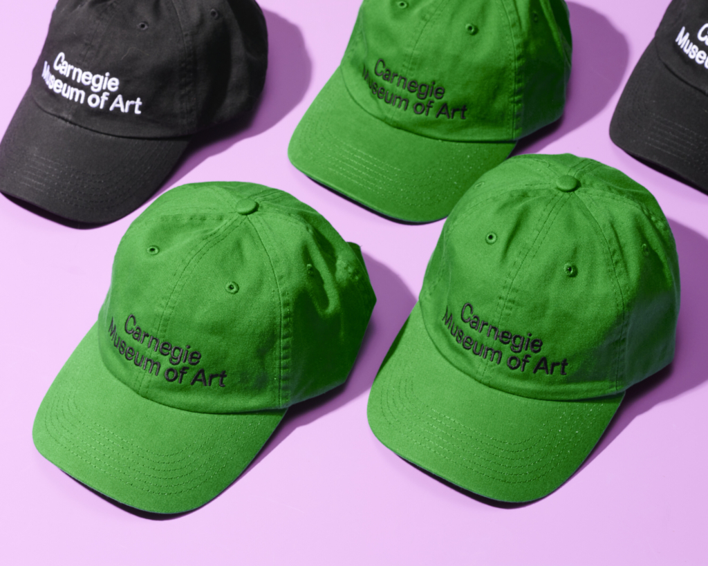 A series of hats that say "Carnegie Museum of Art"
