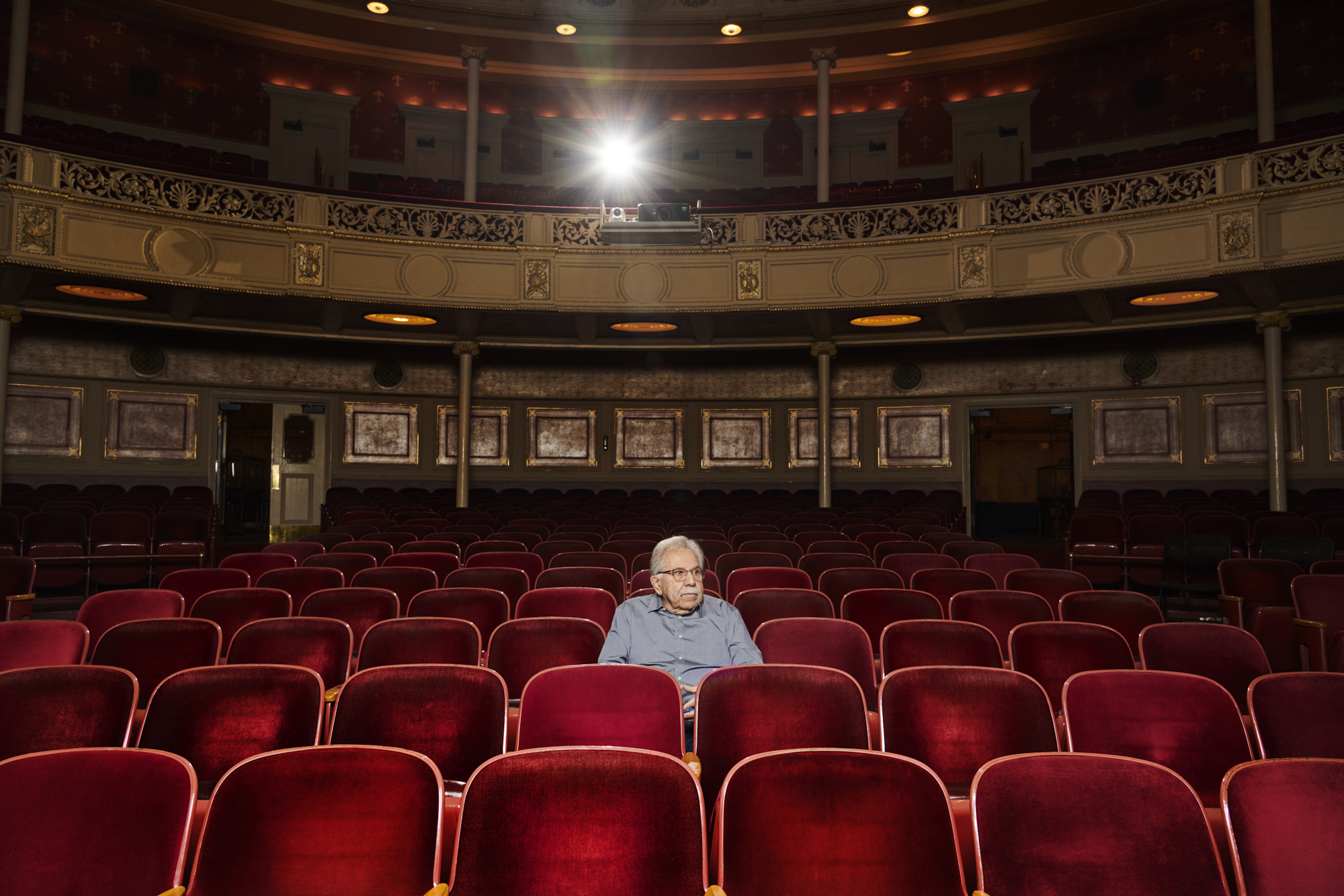 a person sitting alone in a theater
