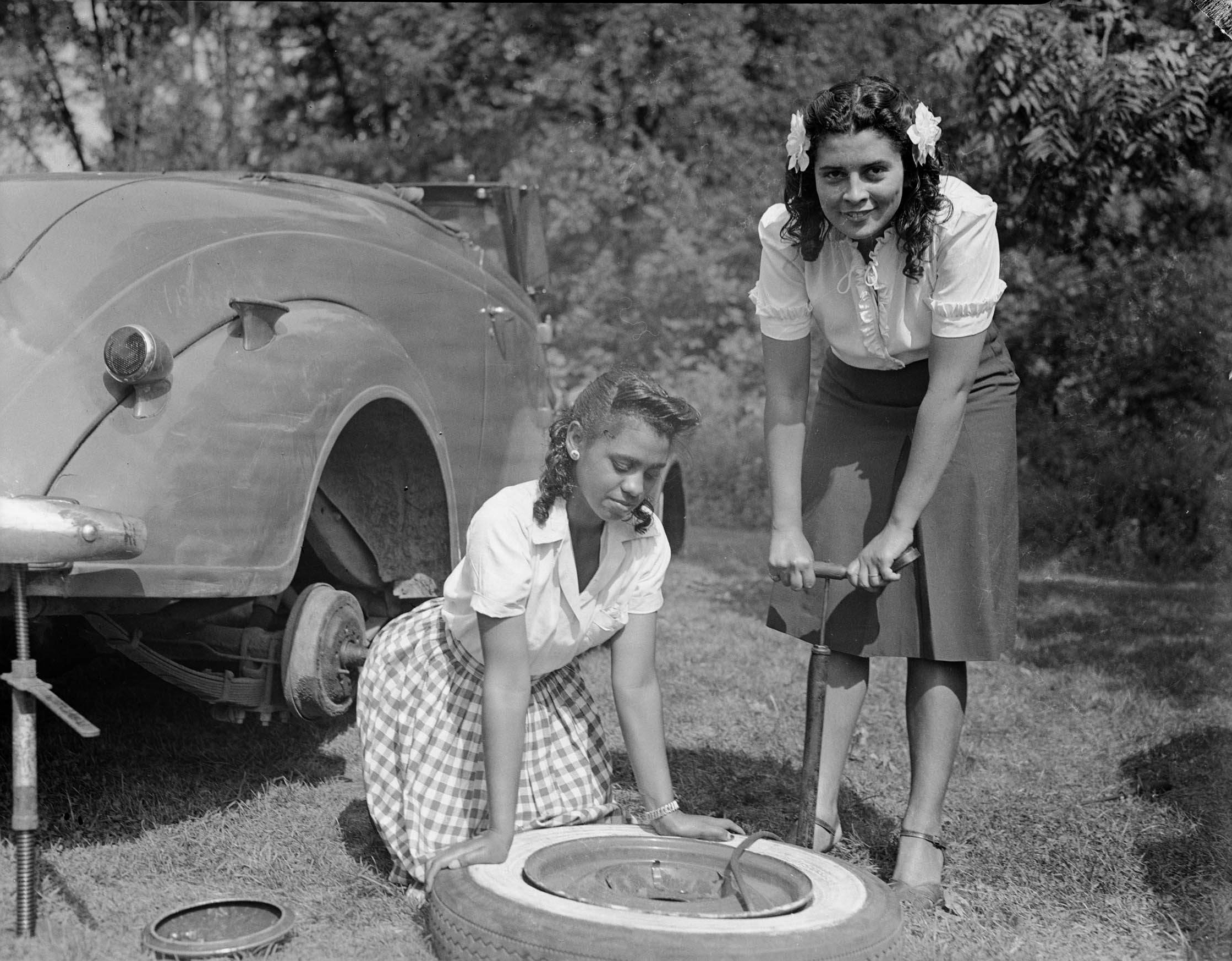 Charles "Teenie" Harris Archive Image of two women pumping air into a tire