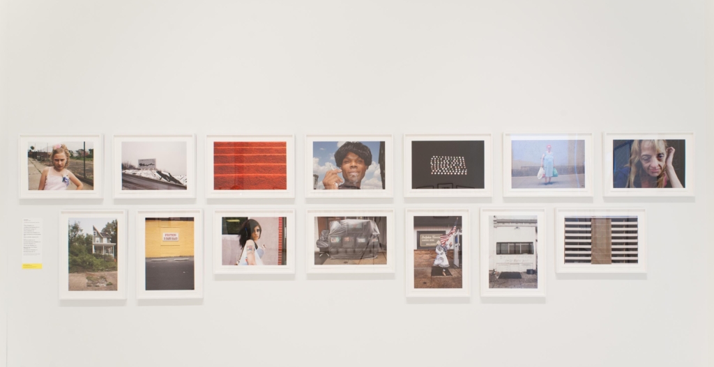 Outtakes Exhibition Image displaying a series of photographs by featured artists in white frames
