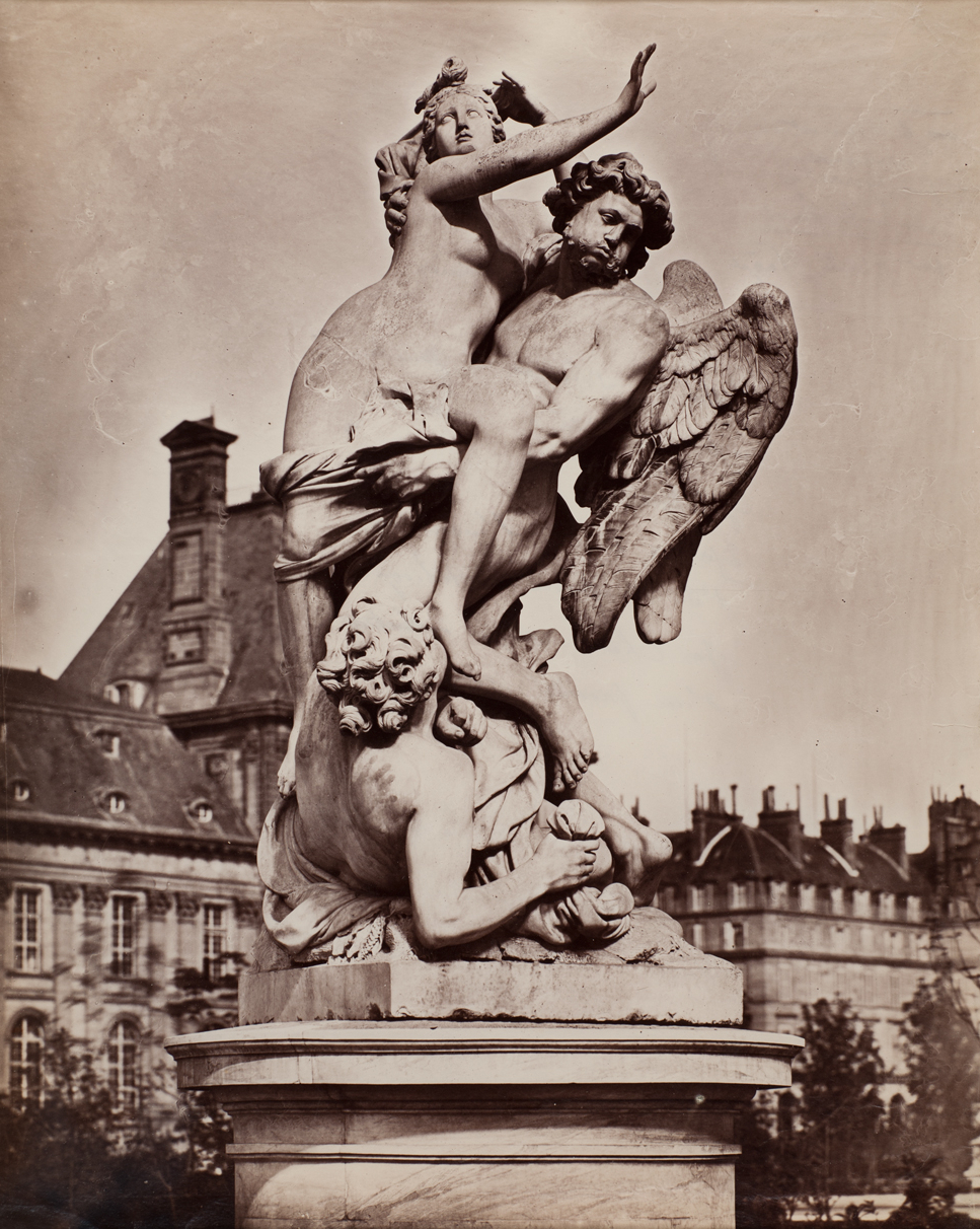 Photo of a statue depicting three figures, one of which has wings