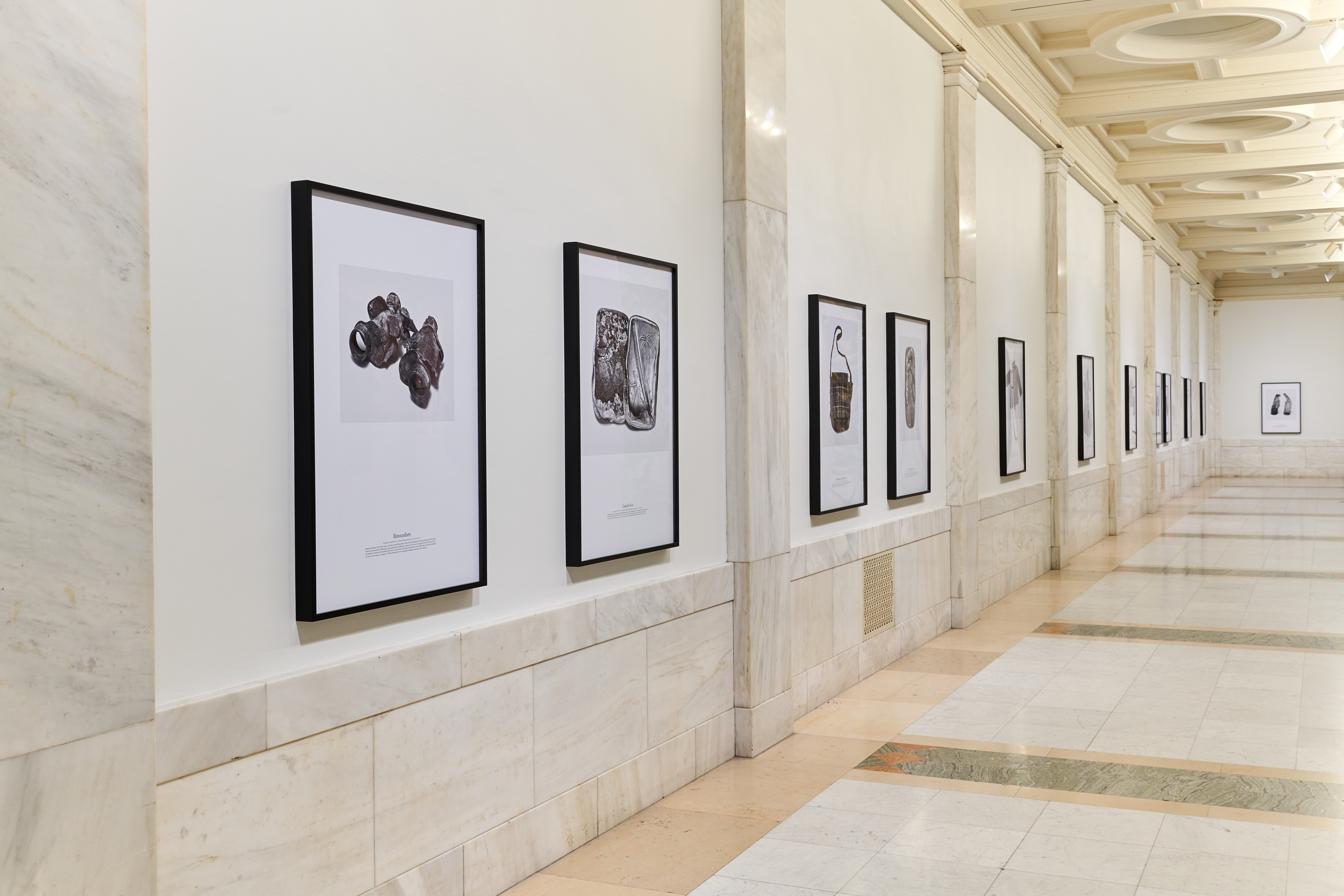 Photographs of various relics after the hiroshima bombing. Including remnants of survivors and deceased. Featured are binoculars, a bento tin, a purse