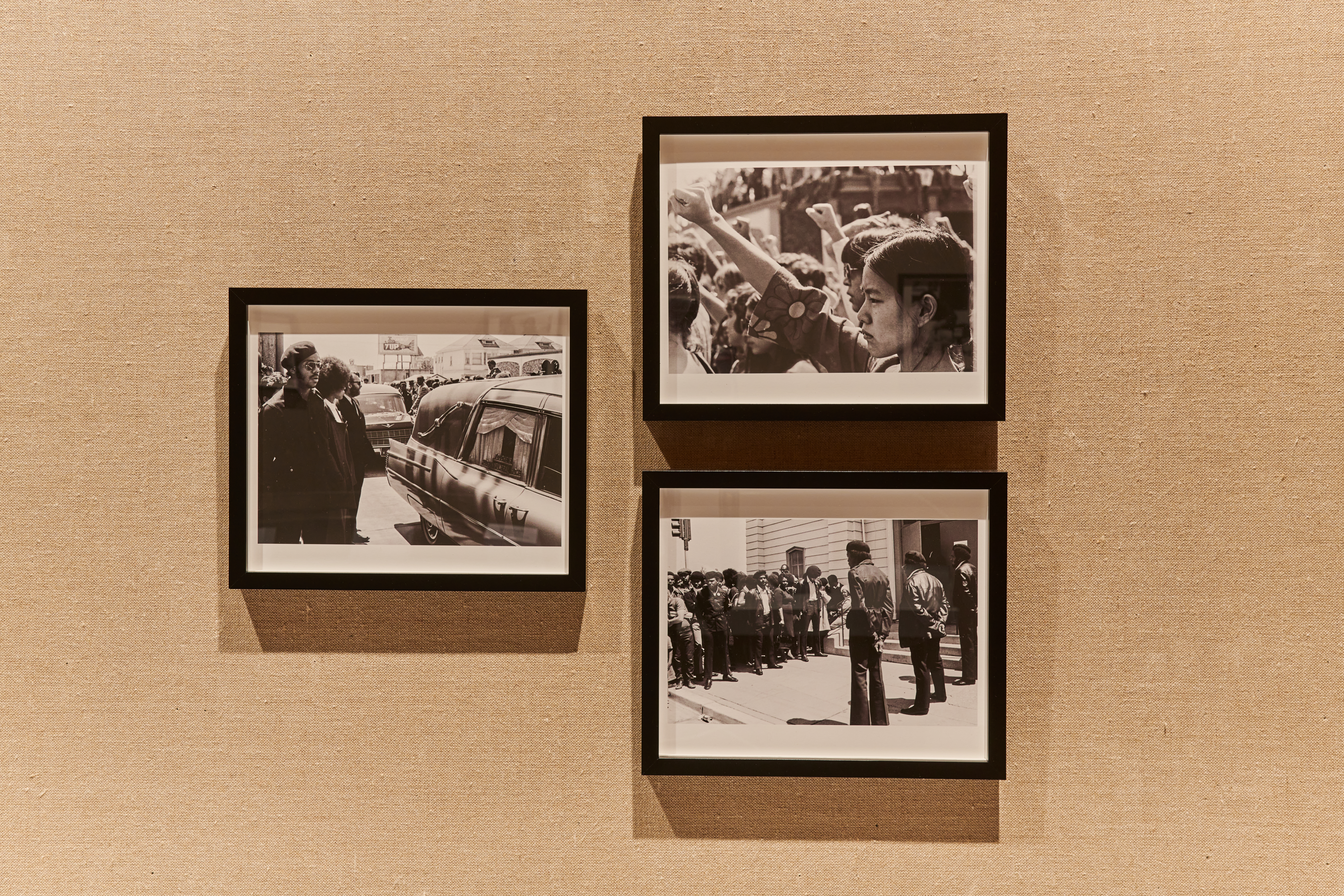 Installation view of the 58th Carnegie International featuring photographs by Nikki Arai of the funeral of Black Panther Jonathan Jackson