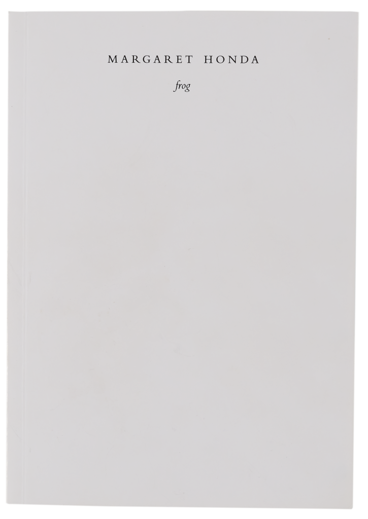 a white book on a grey background.