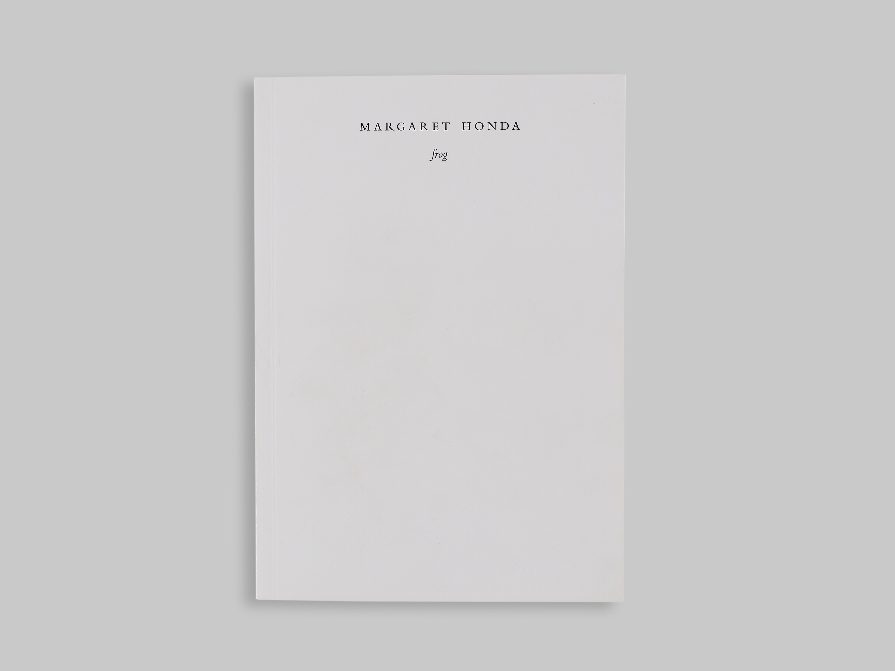 a white book on a grey background.