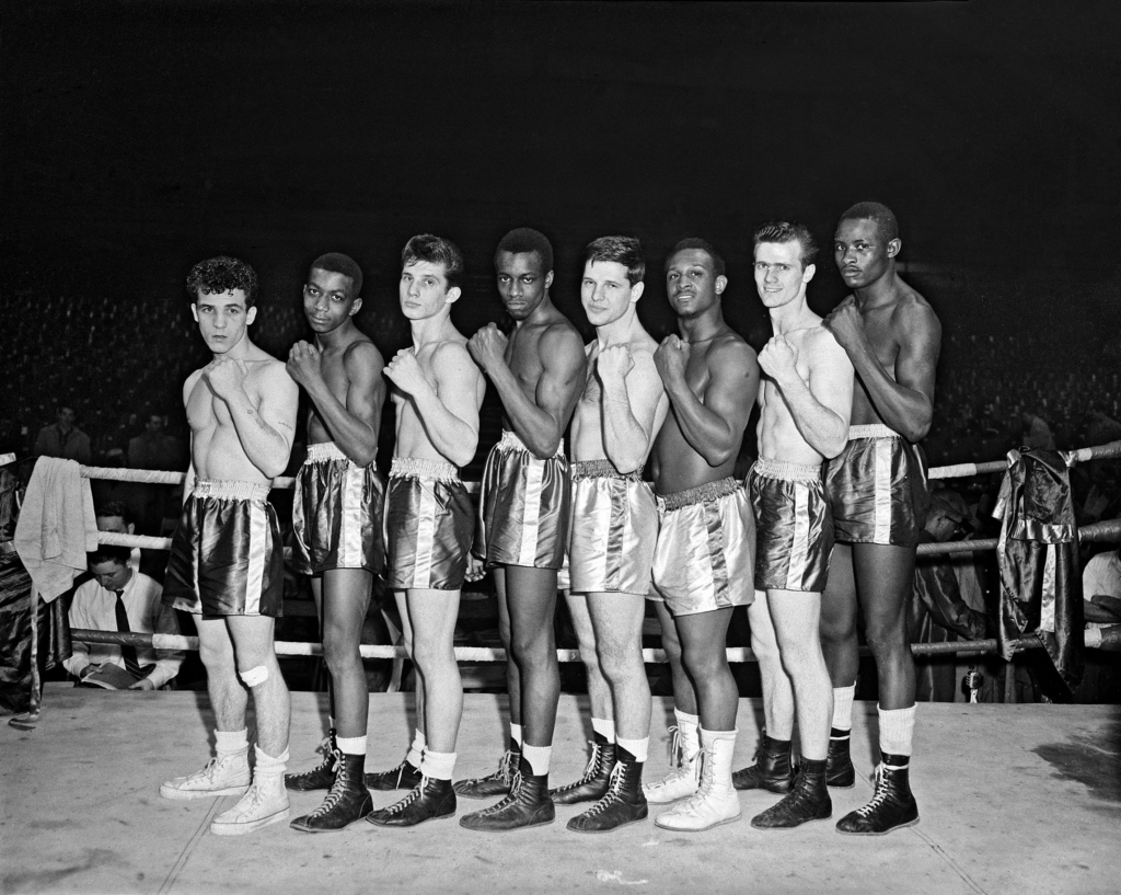 Charles Teenie Harris photo of a group portrait of eight male boxers, possibly Golden Gloves contenders lined up in boxing ring