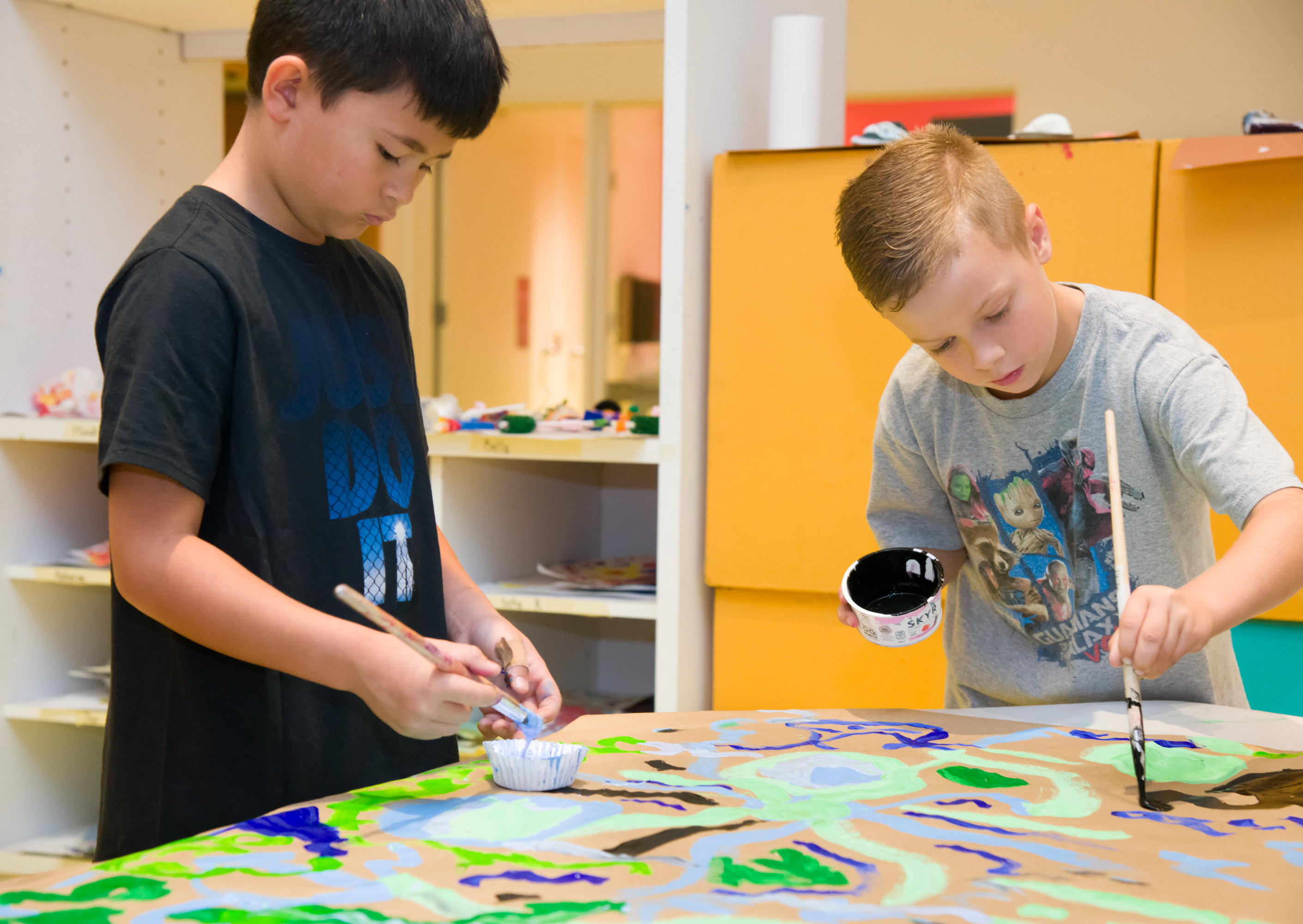 children painting at a summer camp event